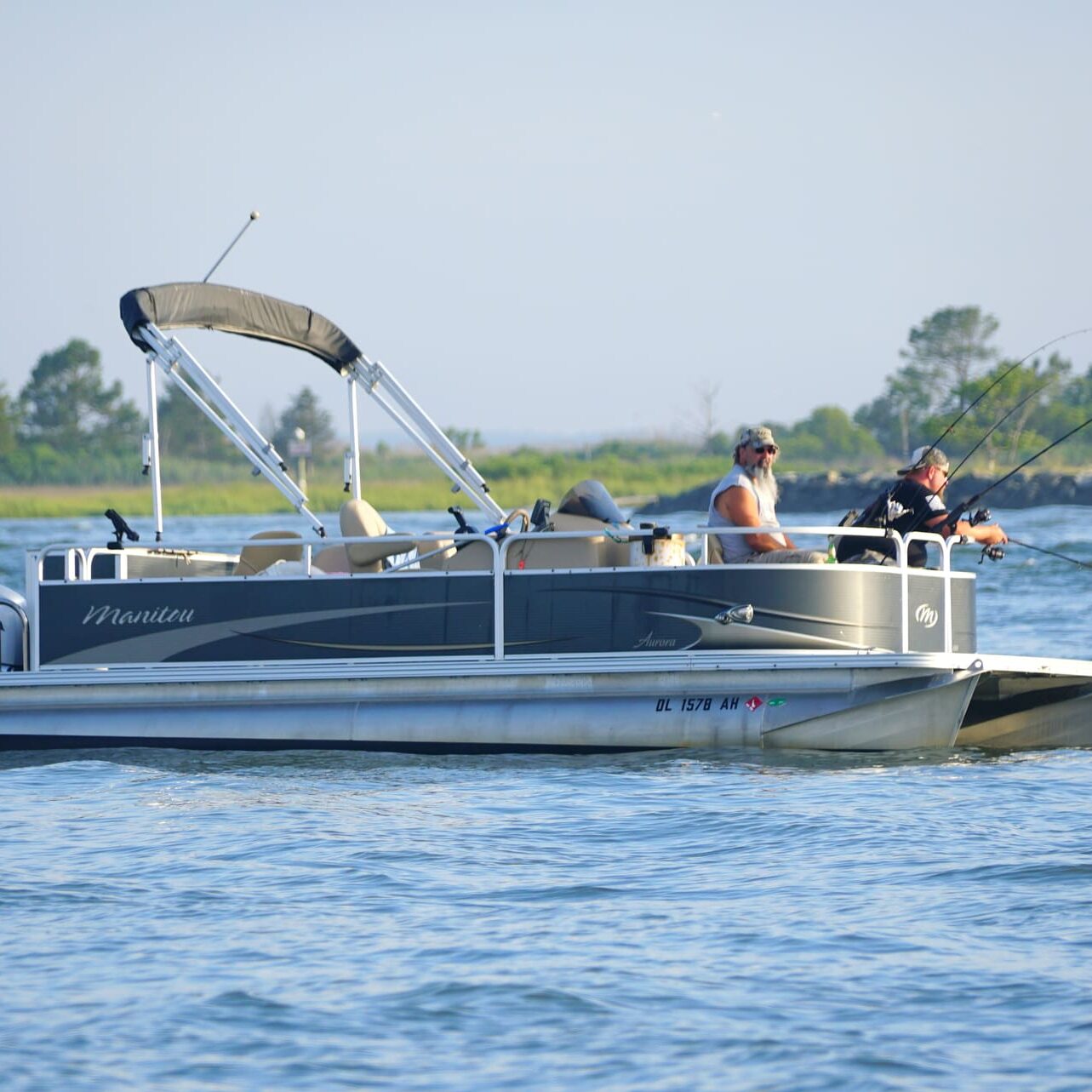 Bethany Beach, Delaware, U.S.A - June 20, 2020 - Anglers on the pontoon boat fishing for flounder near Indian River Inlet in the summer